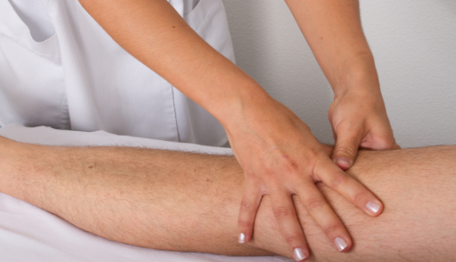 Massage on leg at Cambridge Massage Clinic hands easing muscle tension and knots and promoting healing through targeted therapy.